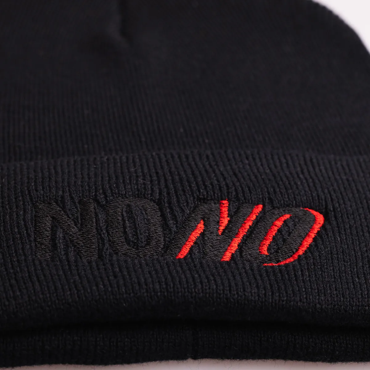Close-up of the NONO embroidery on the beanie cuff